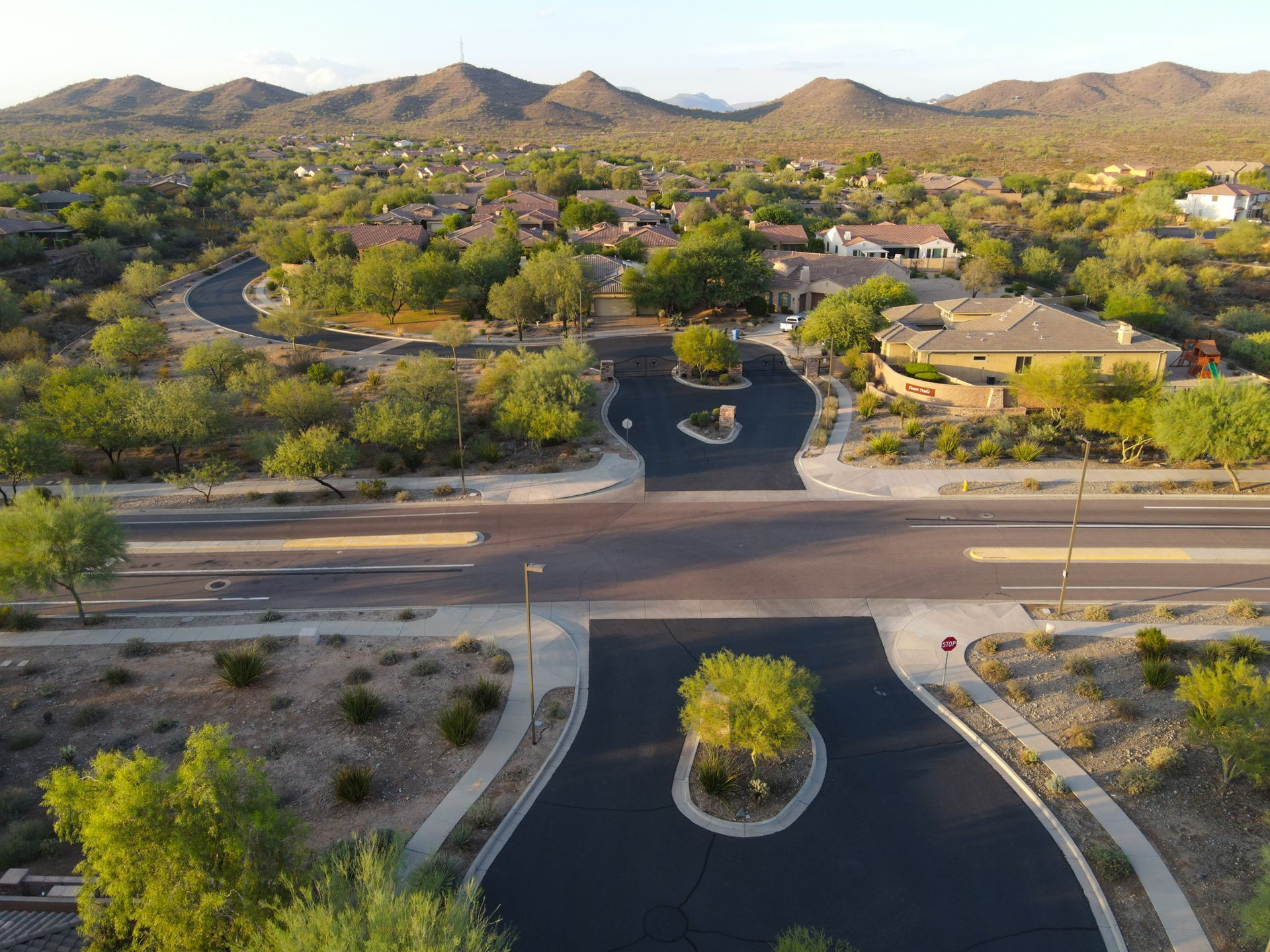 An aerial view of a residential area with mountains in the background