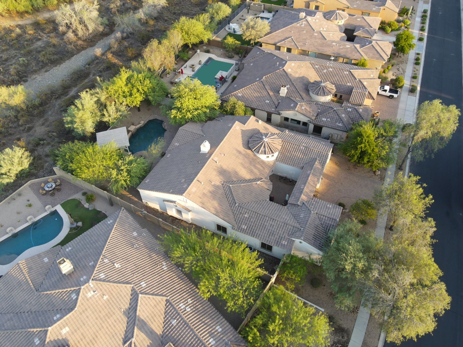An aerial view of a residential area with houses and a pool