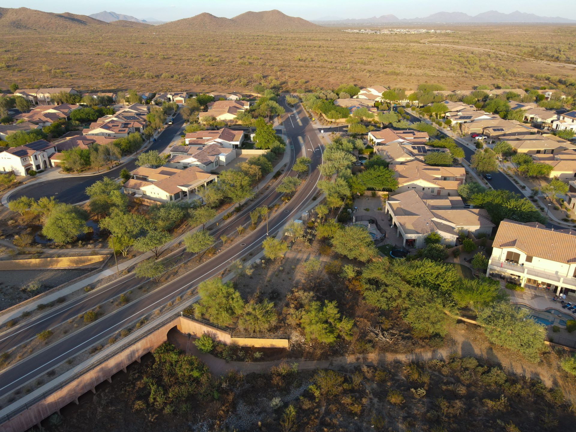 An aerial view of a residential area with a highway going through it