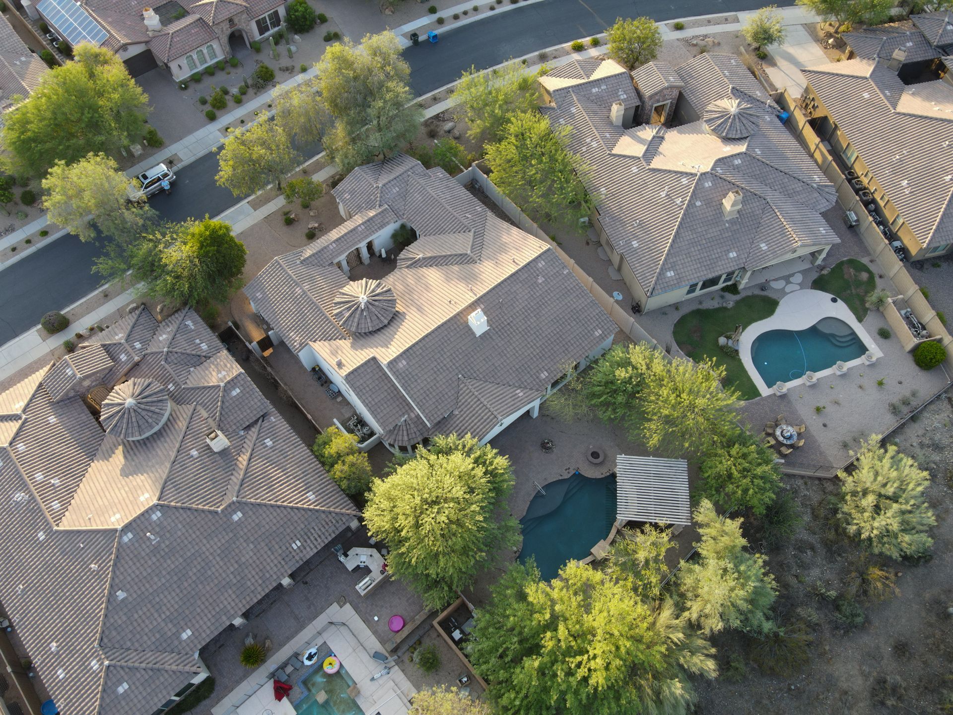 An aerial view of a residential area with houses and a pool