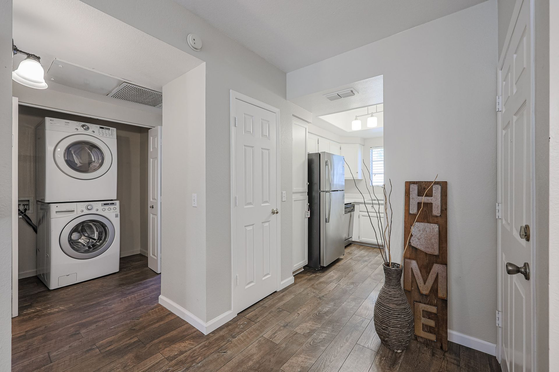 A laundry room with a washer and dryer stacked on top of each other.