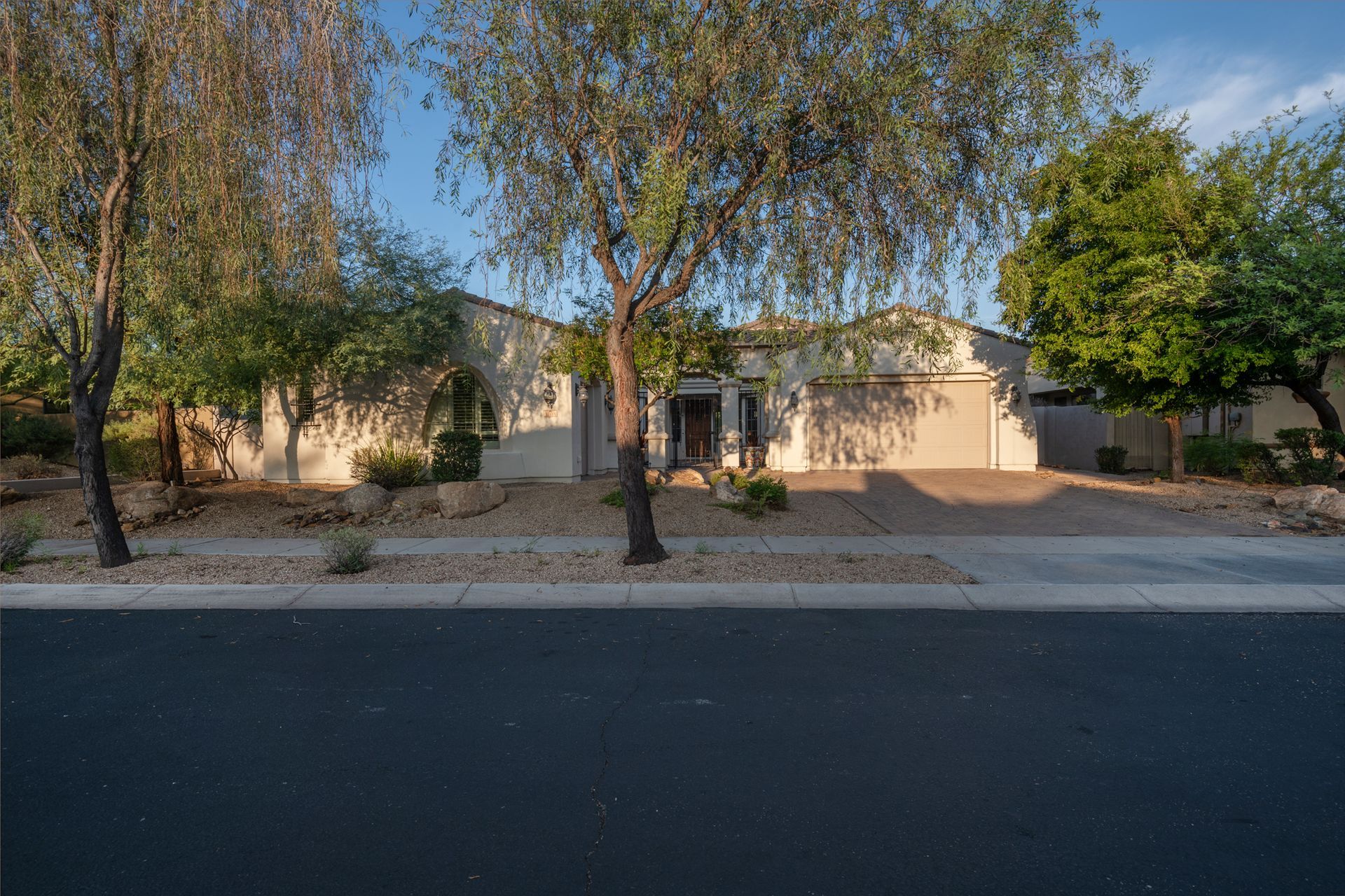 A house with a lot of trees in front of it is for sale.