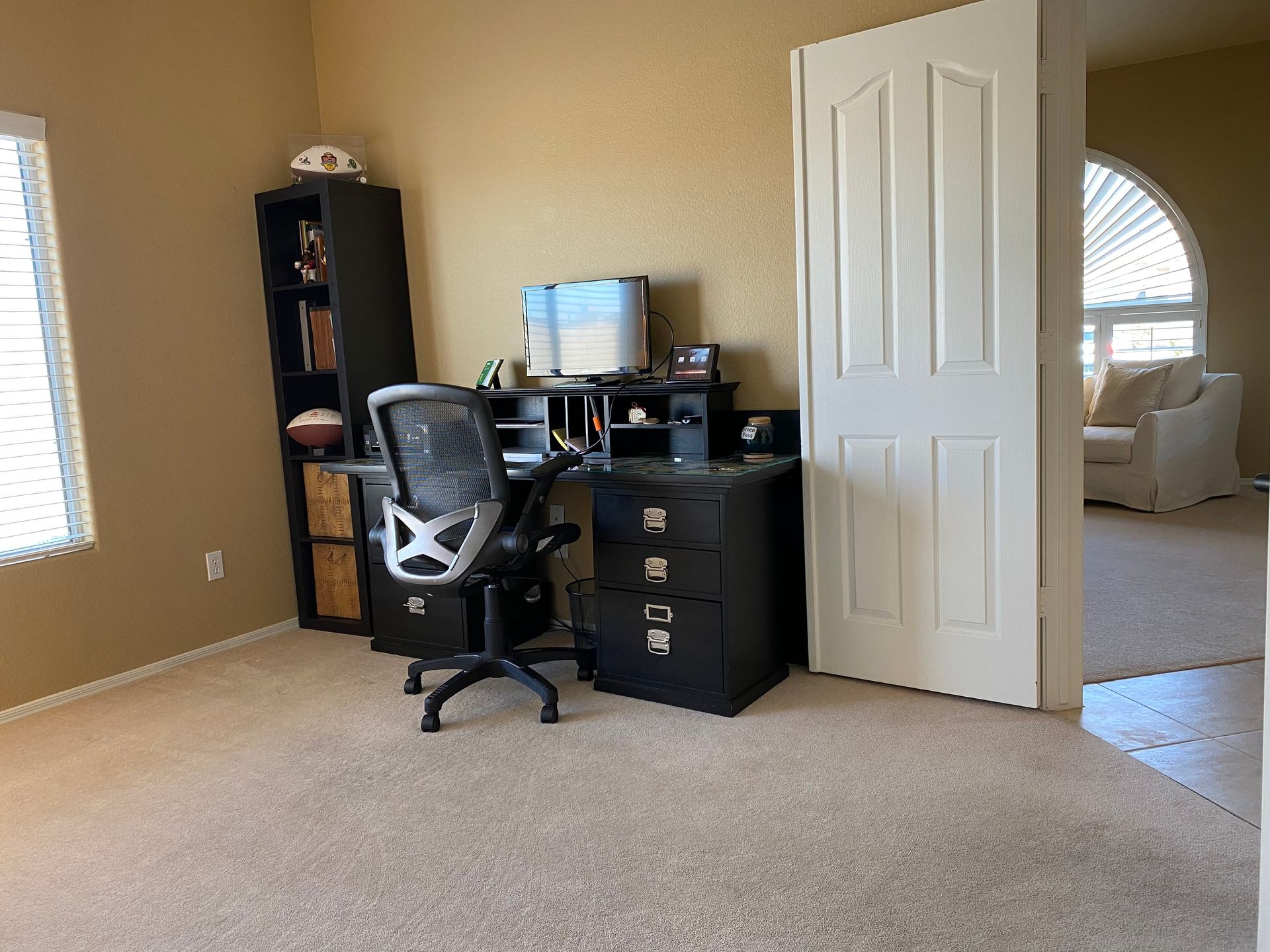 A room with a desk and chair in it