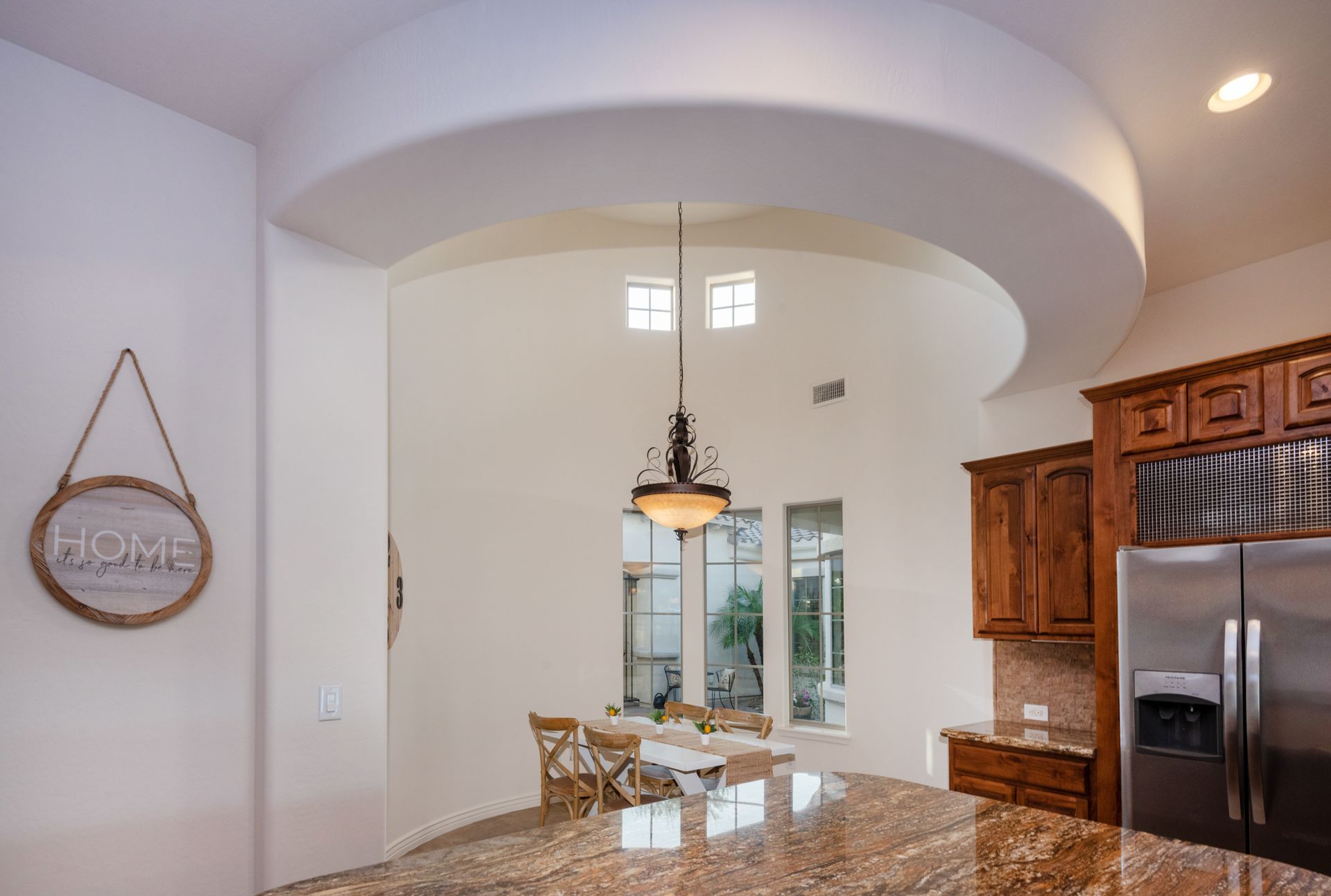 A kitchen with a sign that says home on it