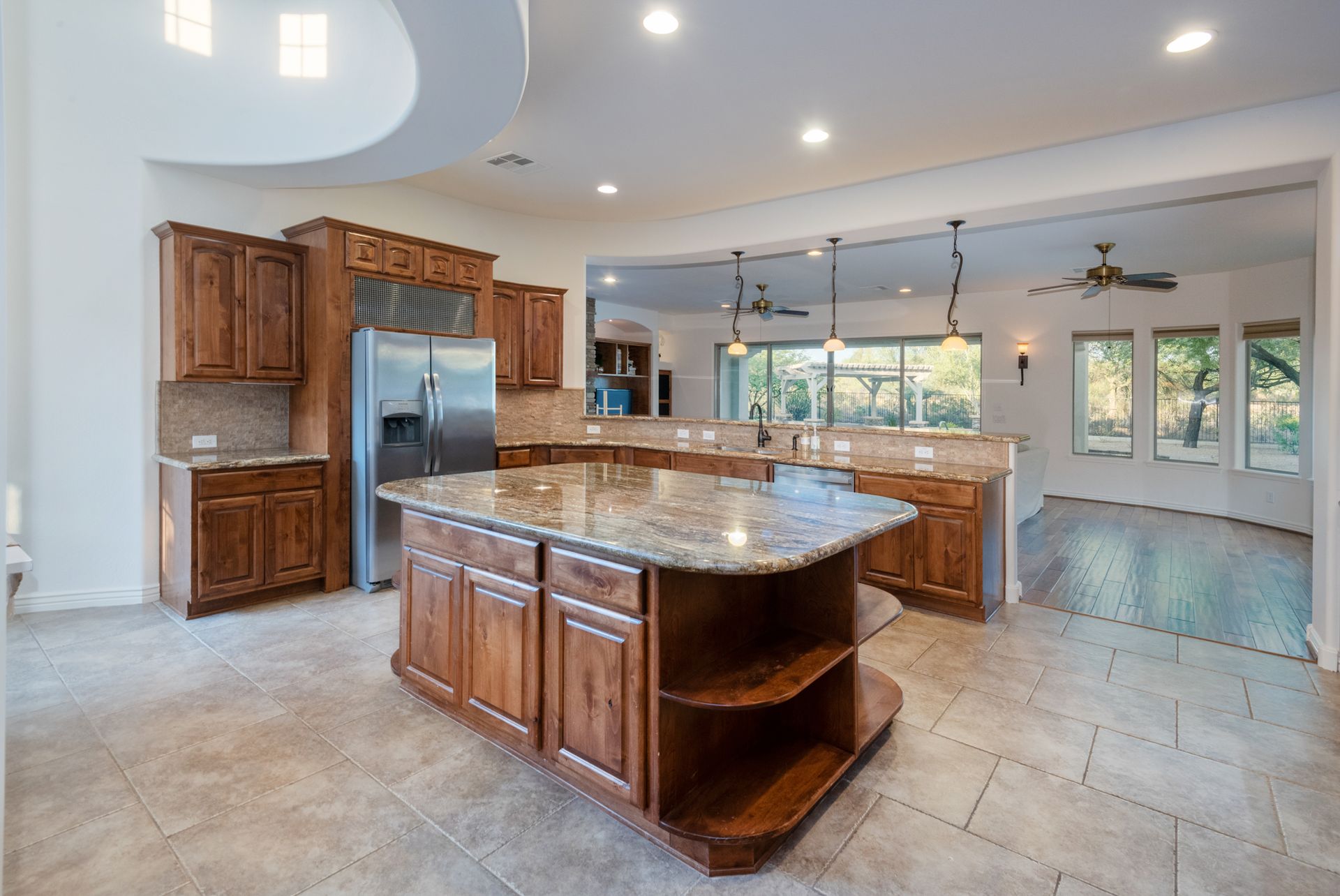 A kitchen with a large island and stainless steel appliances