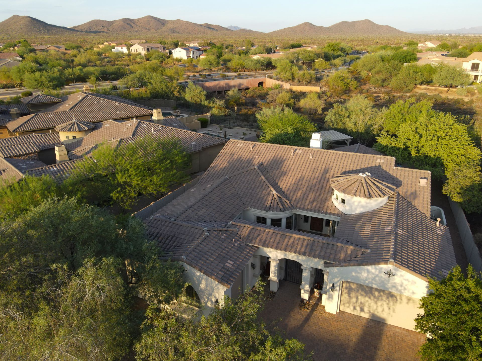 An aerial view of a house with mountains in the background