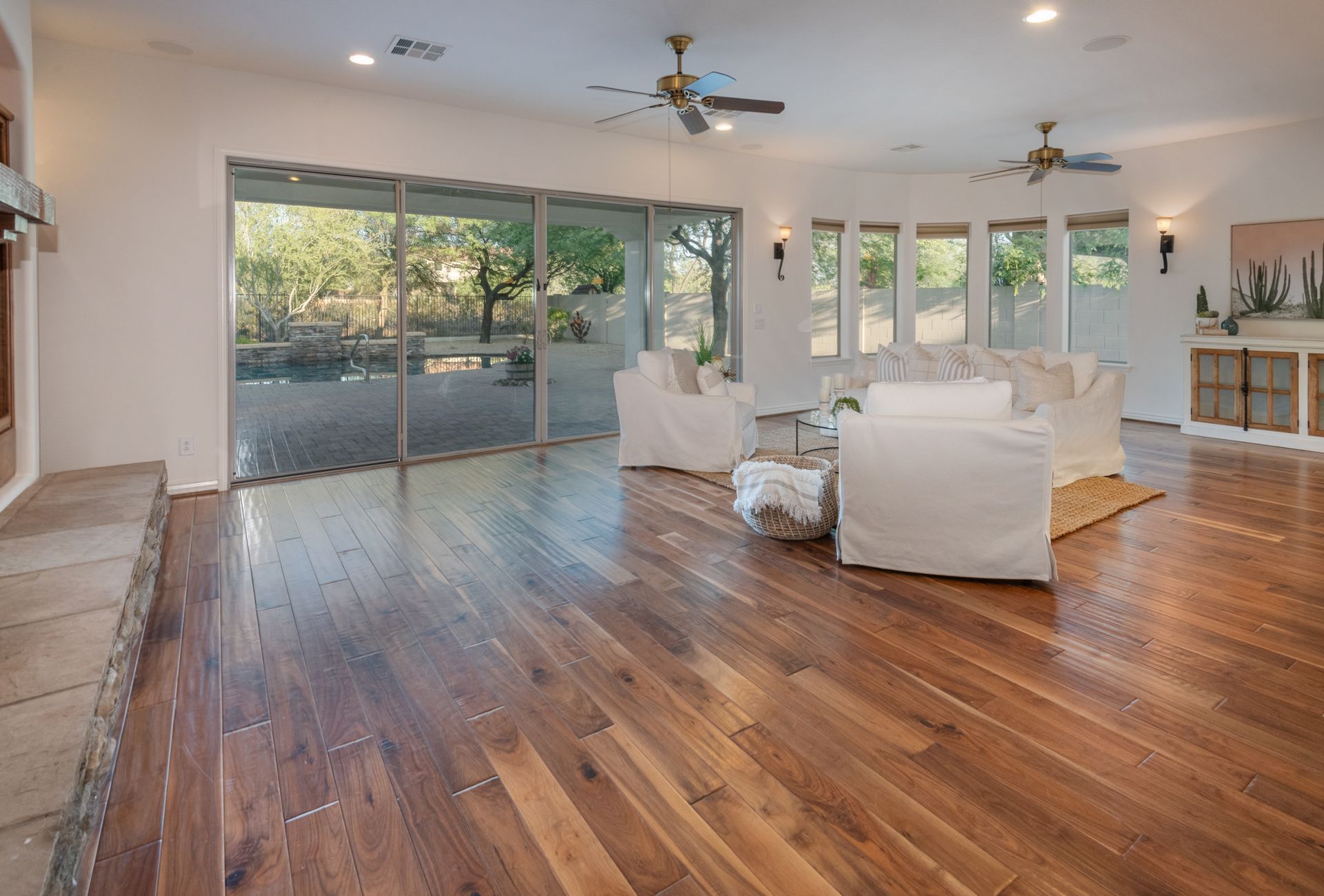 A living room with hardwood floors and a ceiling fan