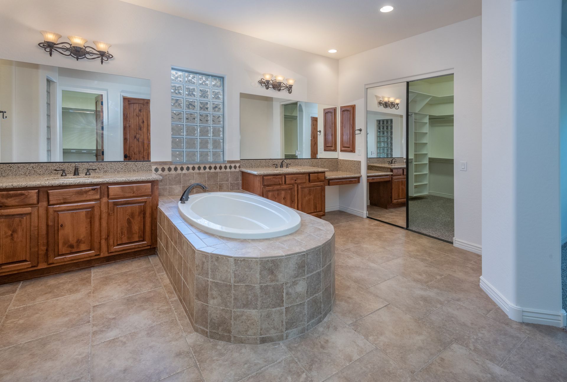 There is a large bathtub in the middle of the bathroom.