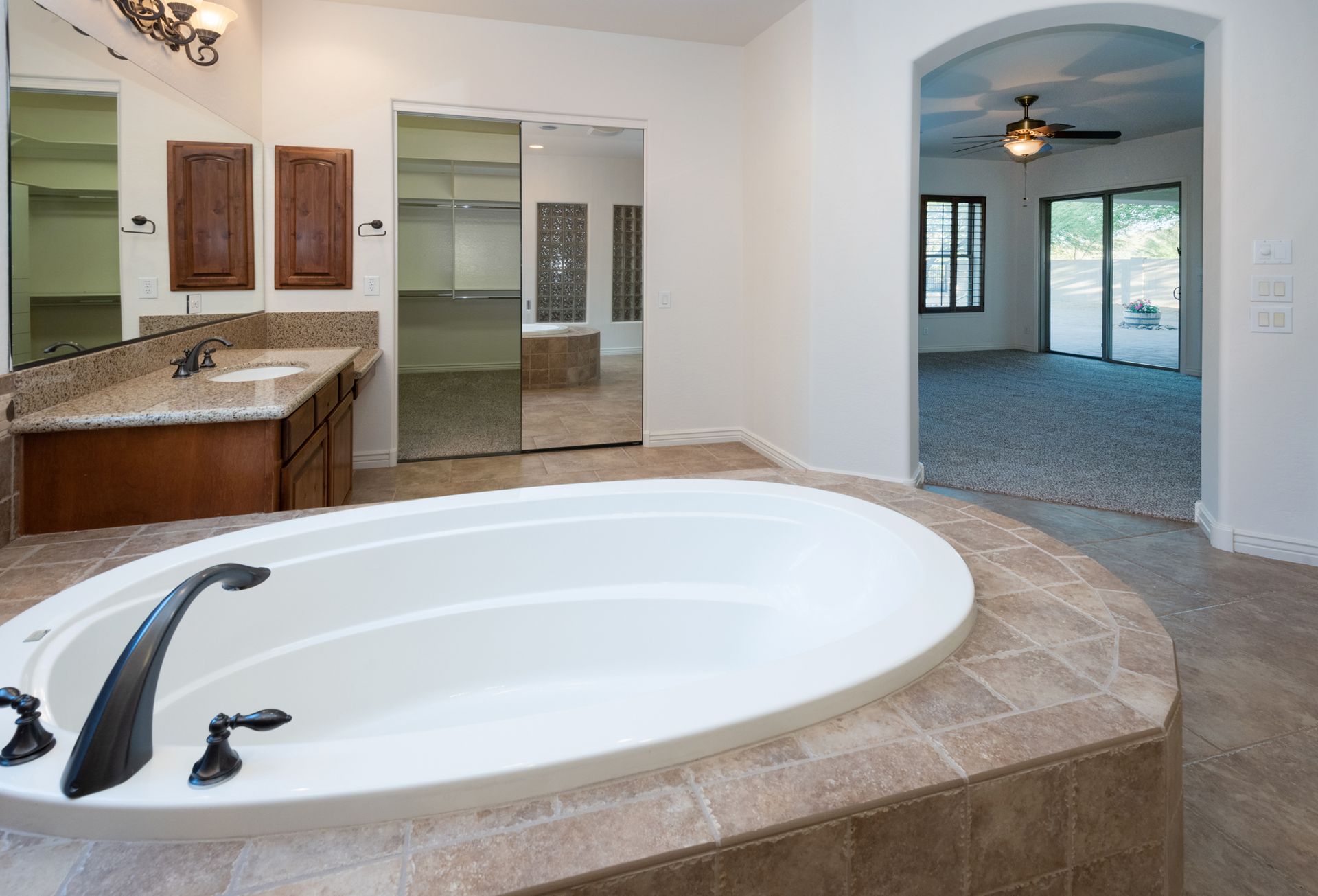 There is a large bathtub in the middle of the bathroom.