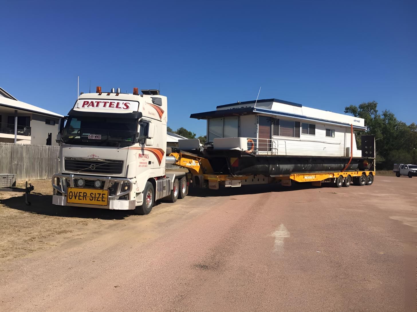 A Truck Is Carrying A House On A Trailer — Pattel's Heavy Haulage Townsville Pty Ltd In Garbutt, QLD