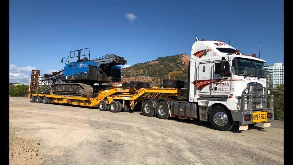 A Semi Truck Is Carrying A Bulldozer On A Trailer — Pattel's Heavy Haulage Townsville Pty Ltd In Garbutt, QLD
