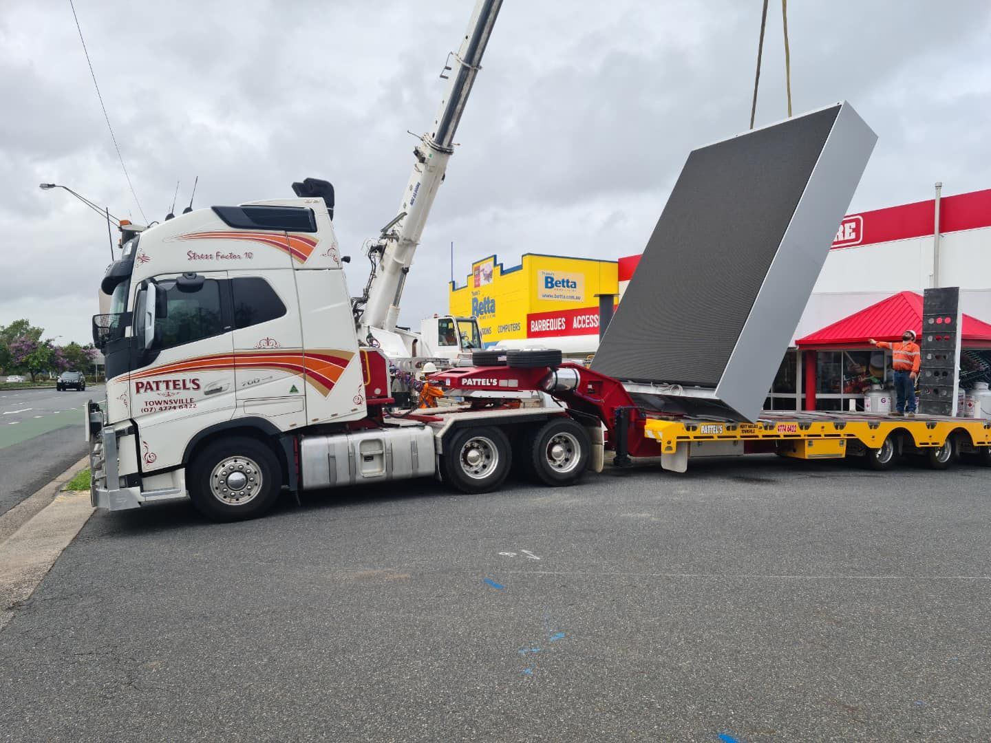 A Large Truck Is Being Towed By A Crane — Pattel's Heavy Haulage Townsville Pty Ltd In Garbutt, QLD