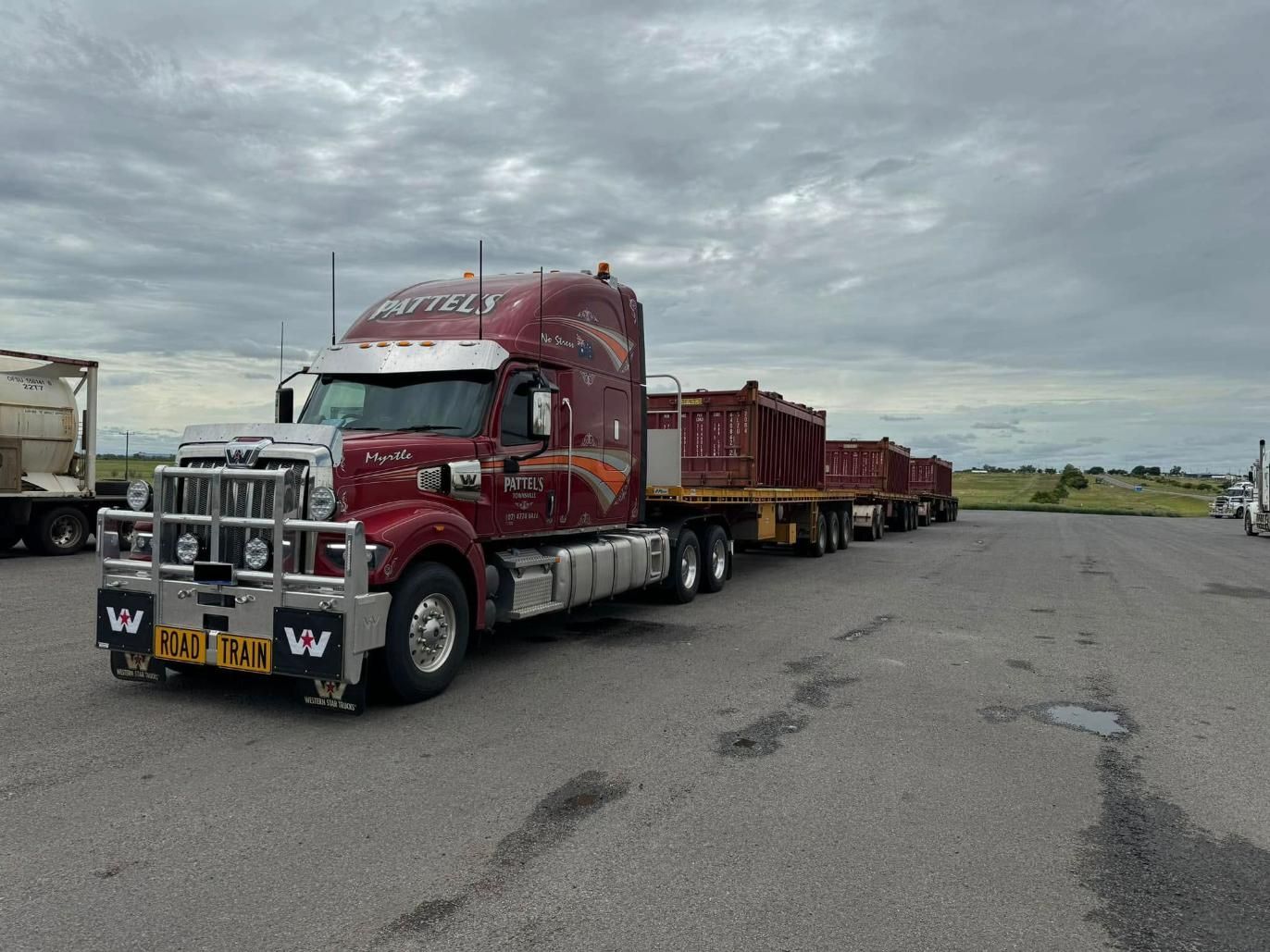 A Red Semi Truck Is Parked In A Parking Lot — Pattel's Heavy Haulage Townsville Pty Ltd In Garbutt, QLD