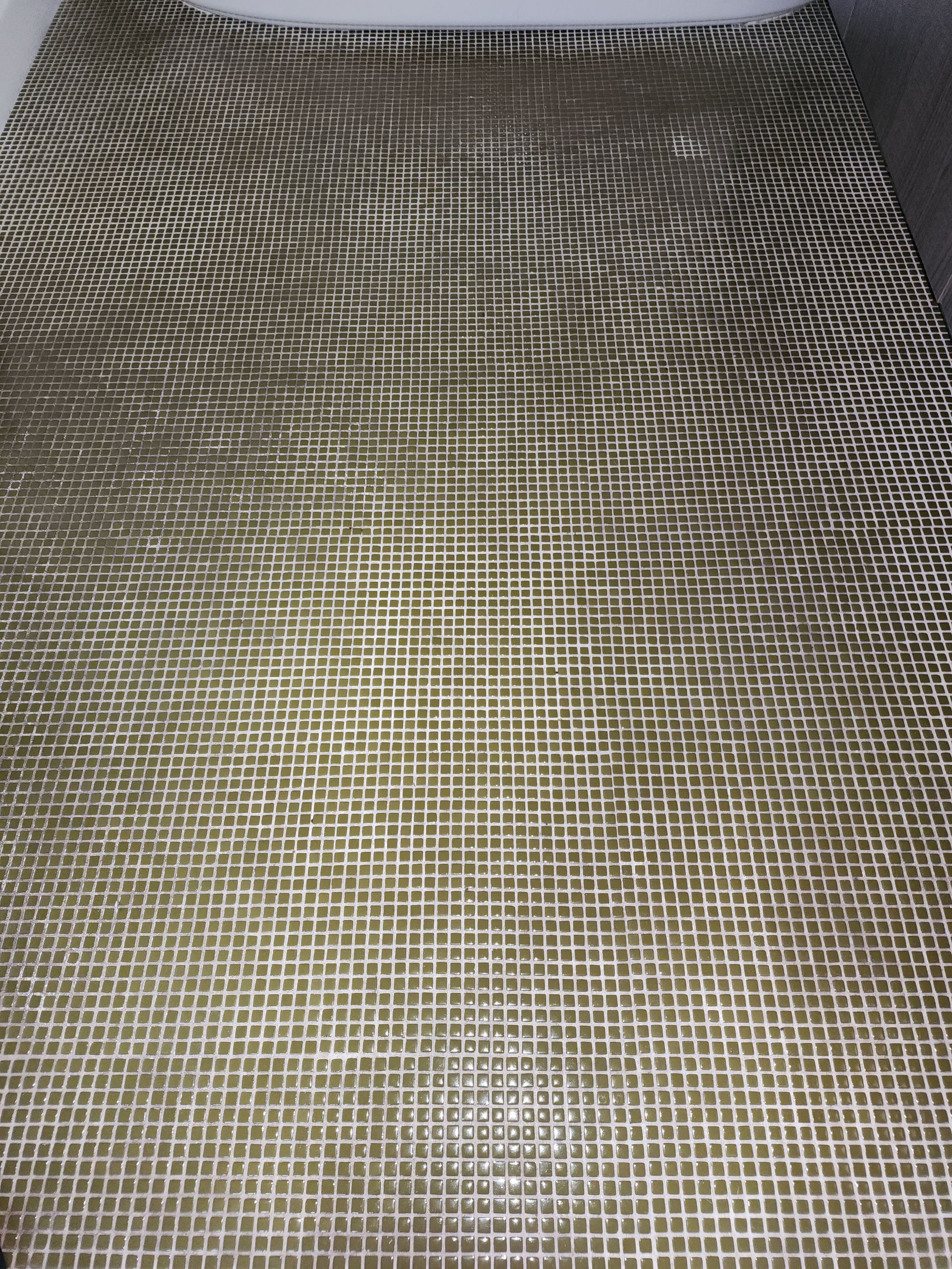 Close-up of a textured beige and gray woven fabric with a faint wavy pattern