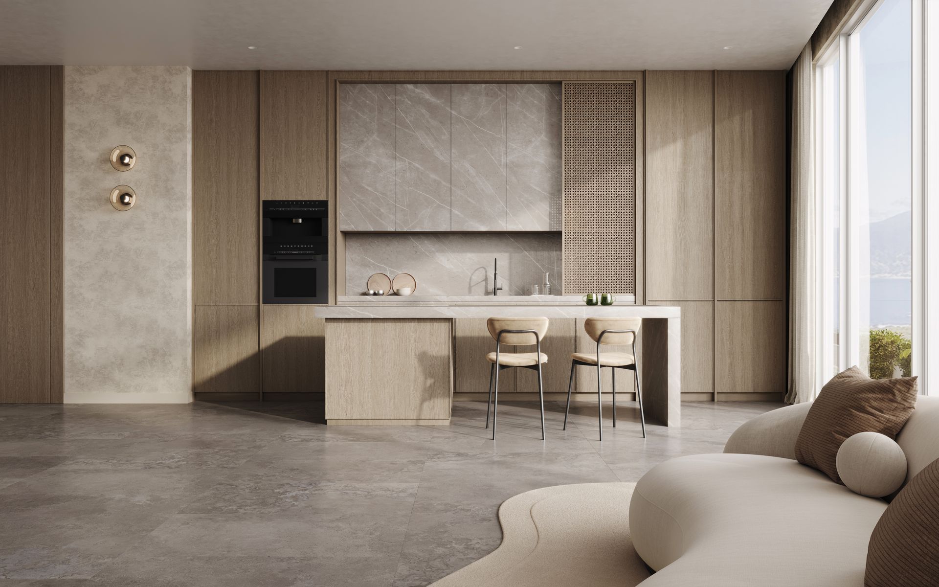Modern kitchen with light wood cabinetry, stone countertops, two bar stools, and a seating area with a sofa.