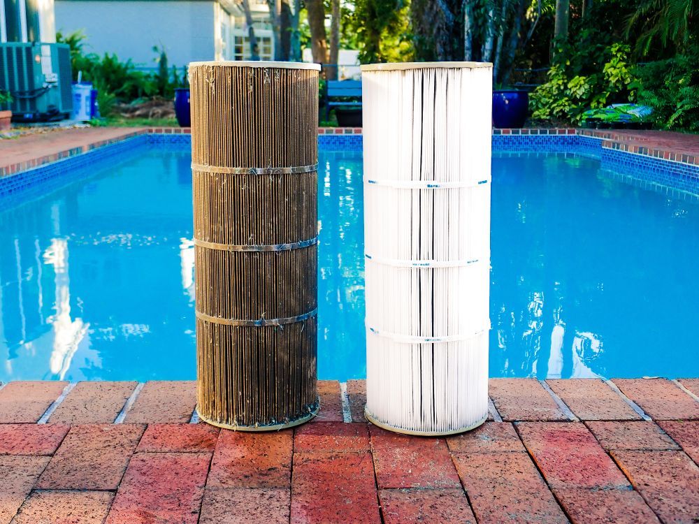 Two Pool Filters Are Sitting Next to Each Other on the Edge — Fannie Bay Pool Shop in Winnellie, NT