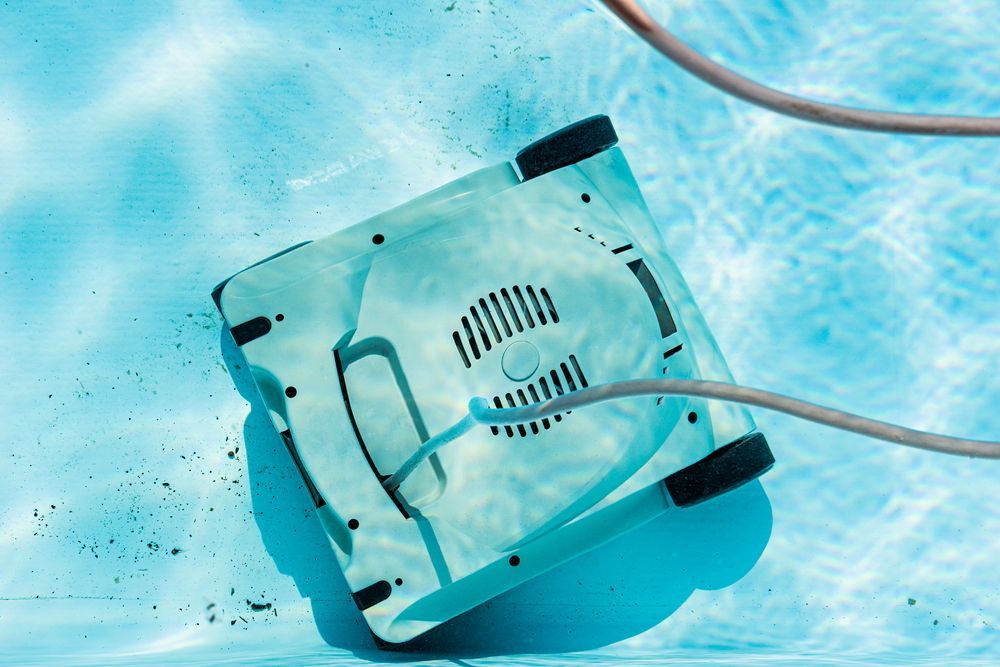 A robotic vacuum cleaner is cleaning the swimming pool — Pool Shop in Darwin, NT