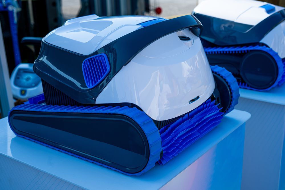 A White and Blue Robotic Pool Cleaner is Sitting on Top — Fannie Bay Pool Shop in Winnellie, NT