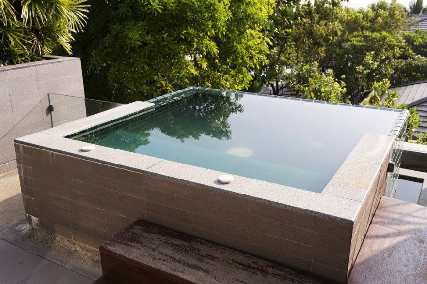 A Large Swimming Pool is Surrounded by Trees on a Balcony — Fannie Bay Pool Shop in Bayview, NT