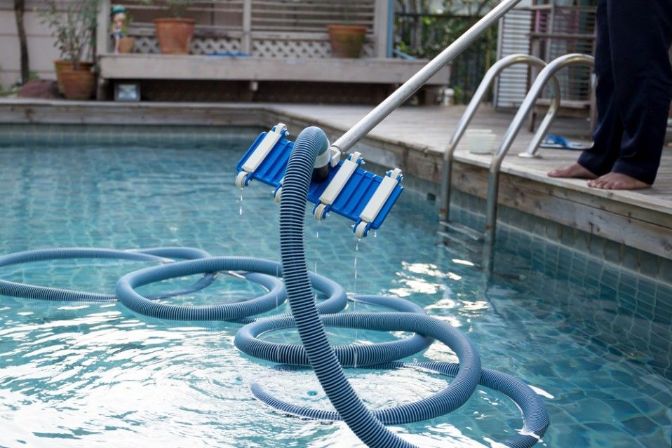 A Person is Cleaning a Swimming Pool — Fannie Bay Pool Shop in Larrakeyah, NT