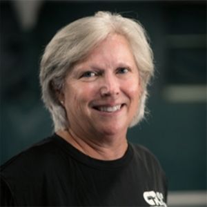 A woman wearing a black shirt with the word gk on it