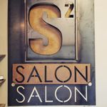 A rustic metal wall sign with a large 