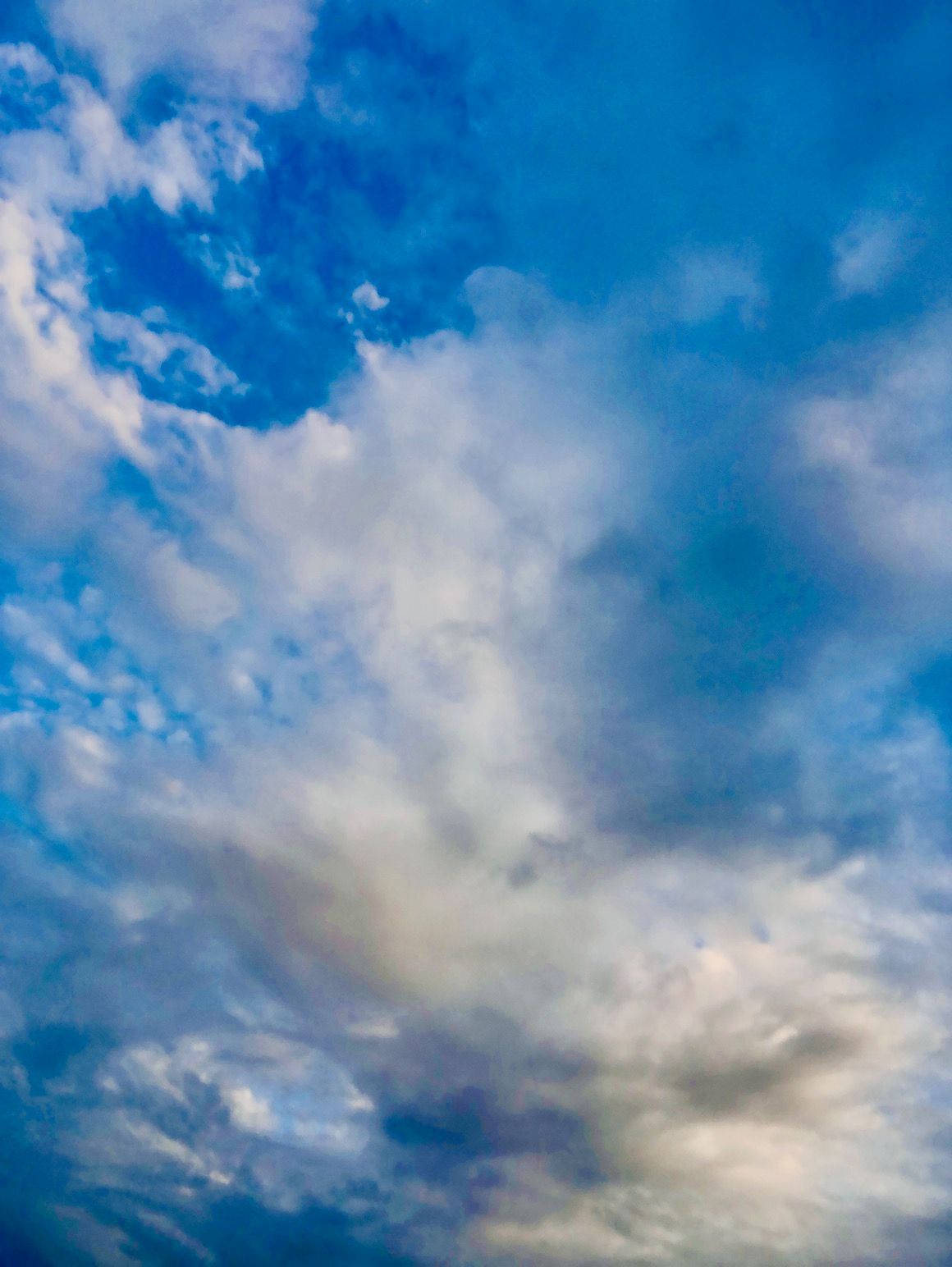 A blue sky with white clouds in it