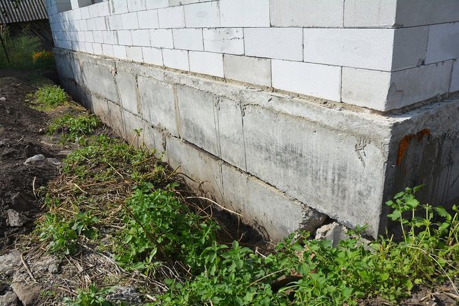 A damaged concrete foundation with visible cracks, showcasing the importance of repair services.