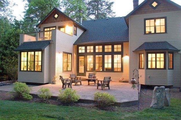 A house with a lot of windows and a patio