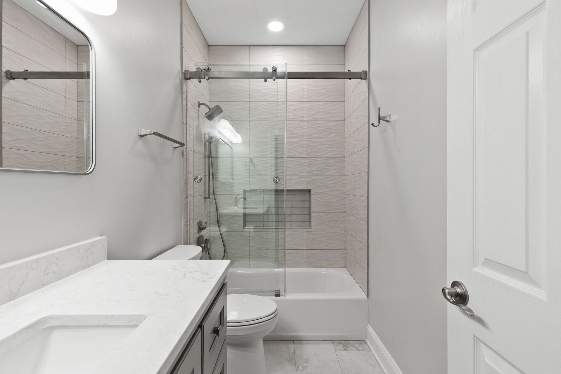 A bathroom with a toilet , sink , shower and tub.