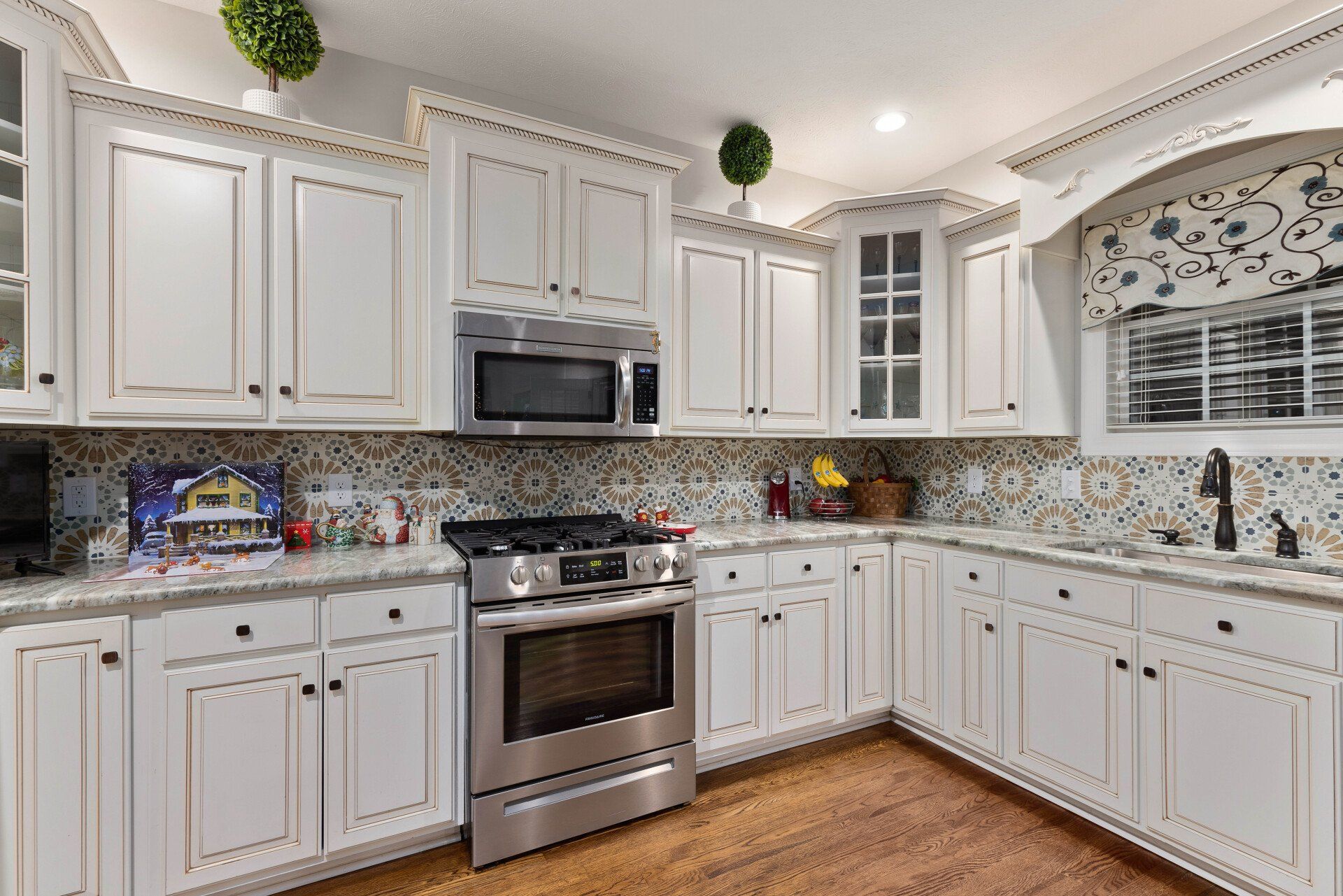A kitchen with white cabinets and stainless steel appliances.