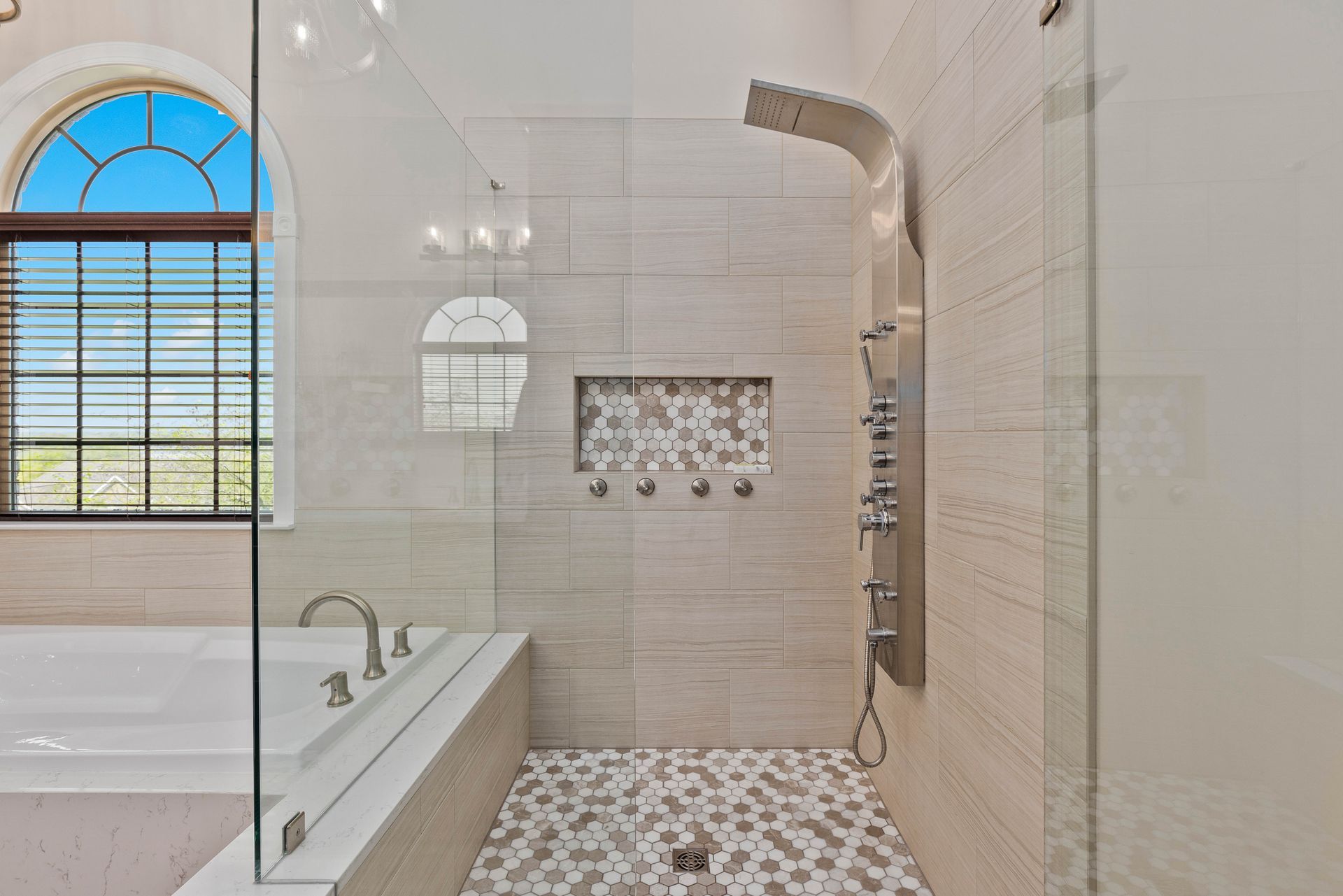 A bathroom with a walk in shower and a bathtub.