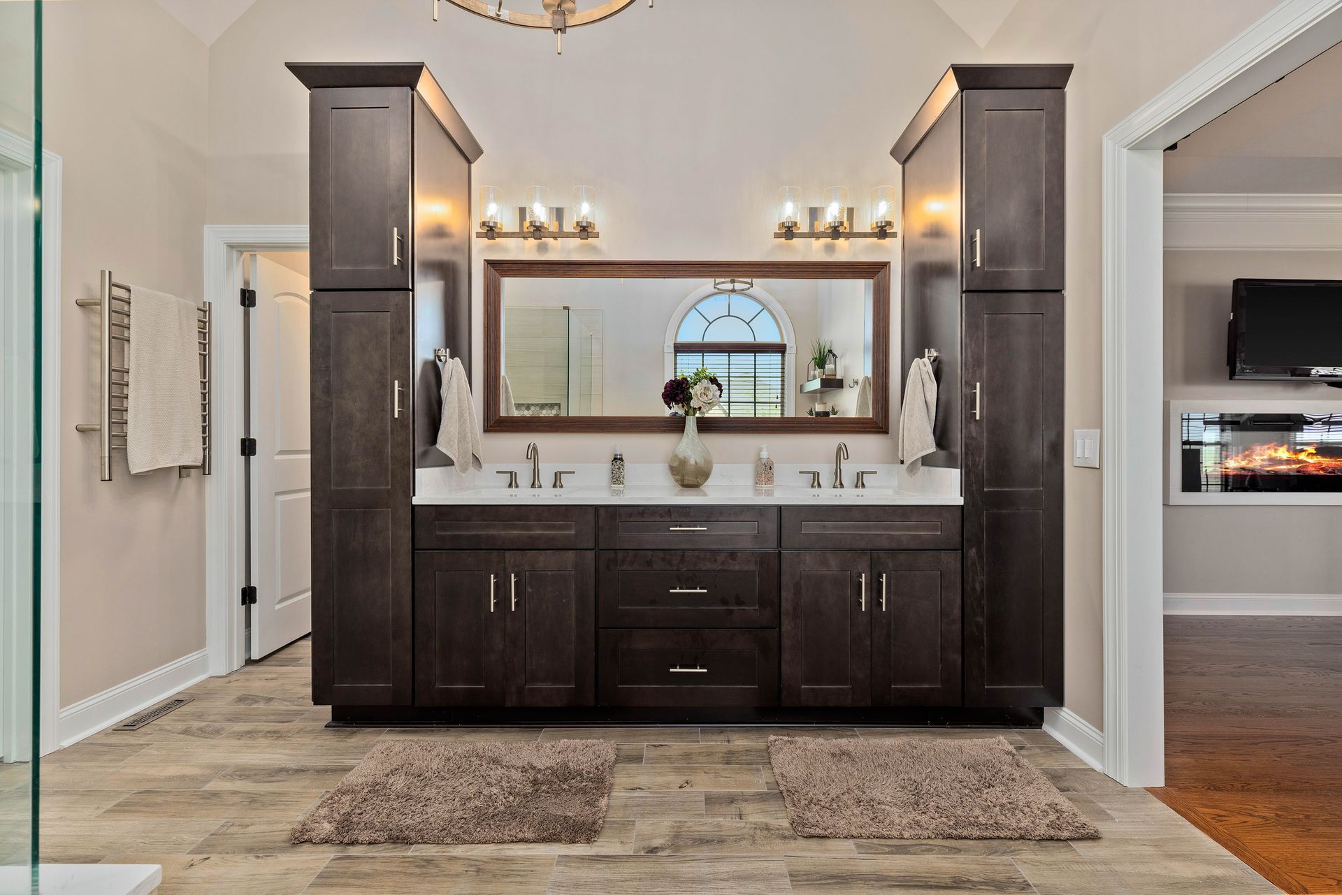 A bathroom with two sinks and a large mirror.