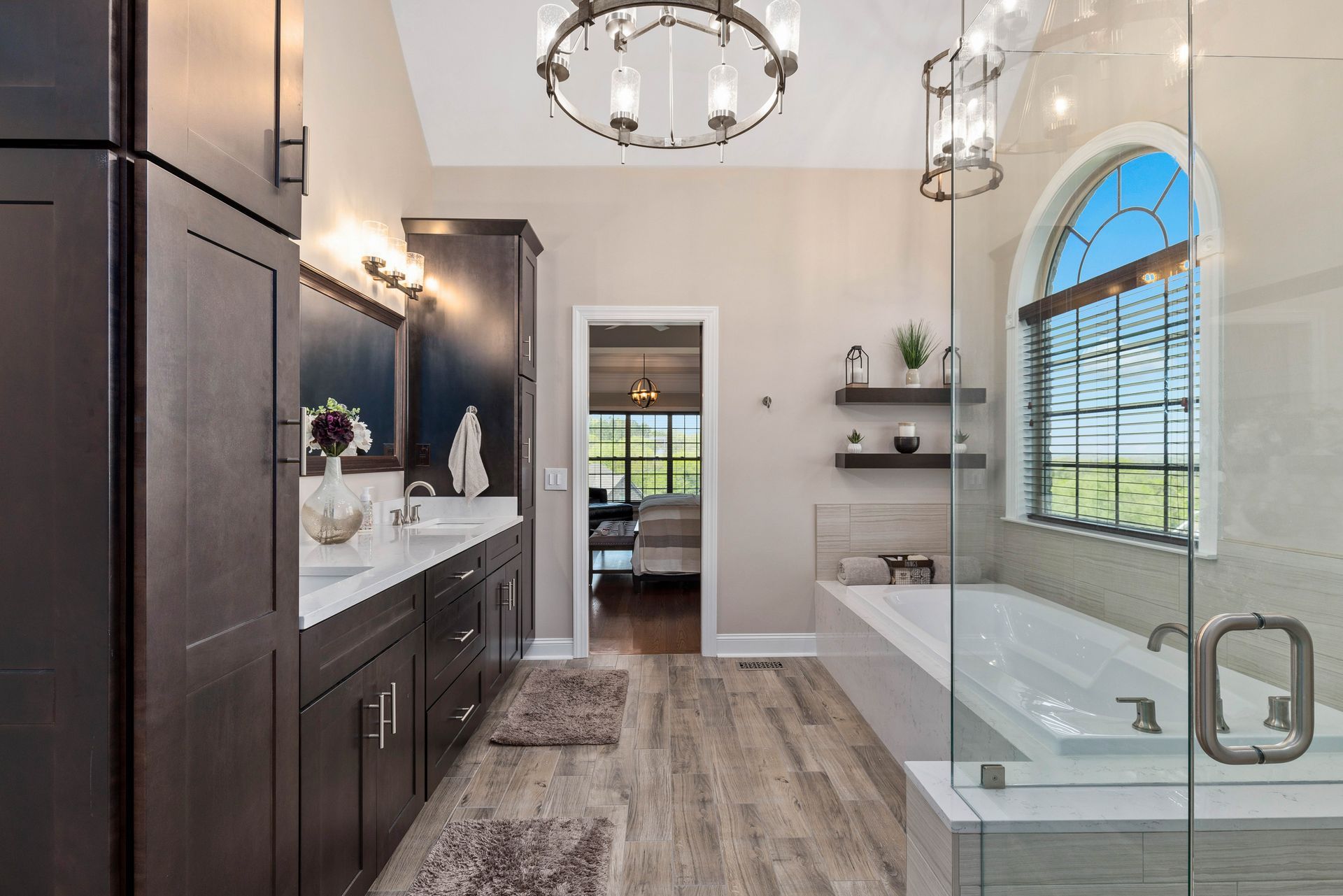 A bathroom with two sinks , a tub , and a walk in shower.