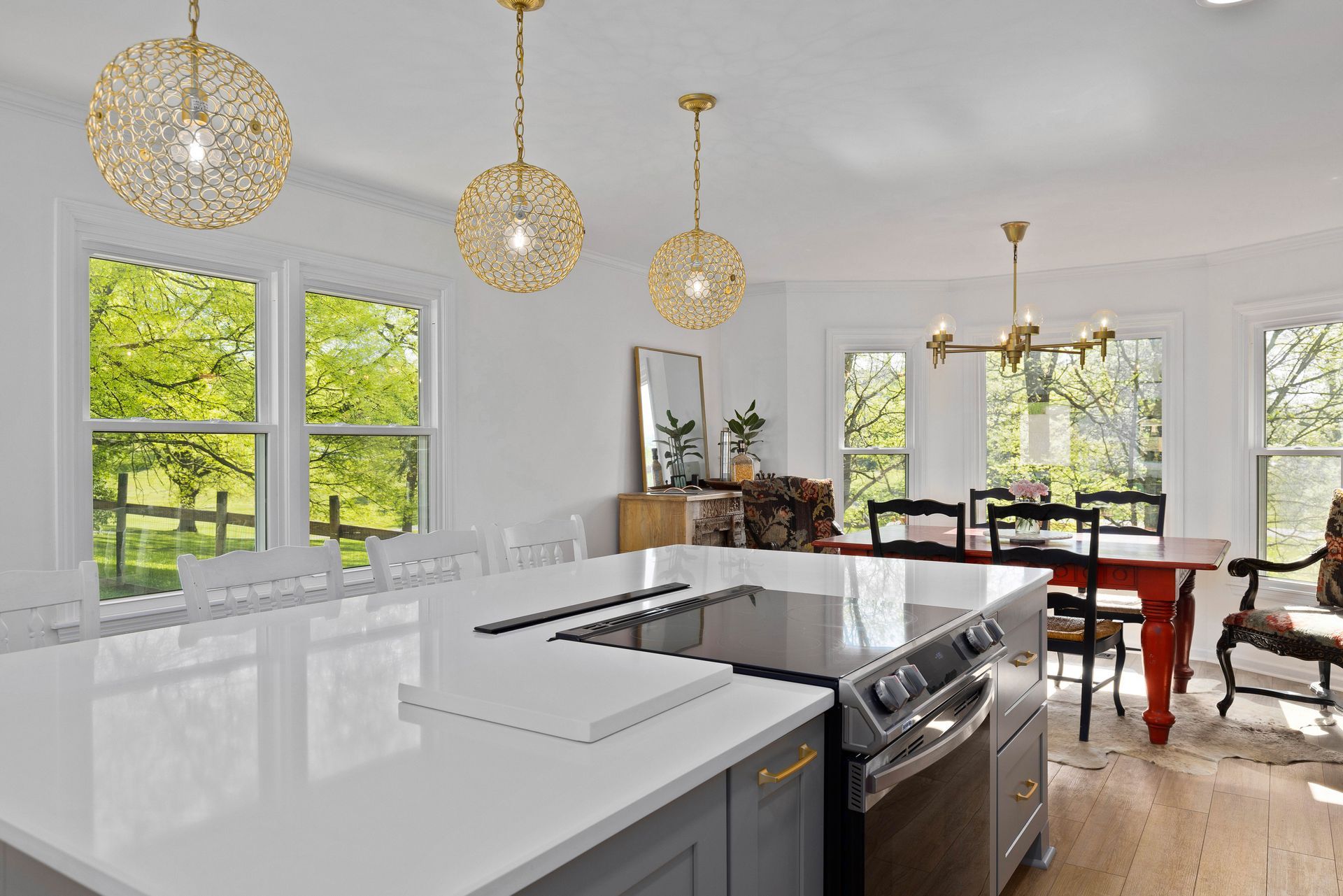 A kitchen with a large island and a stove top oven.