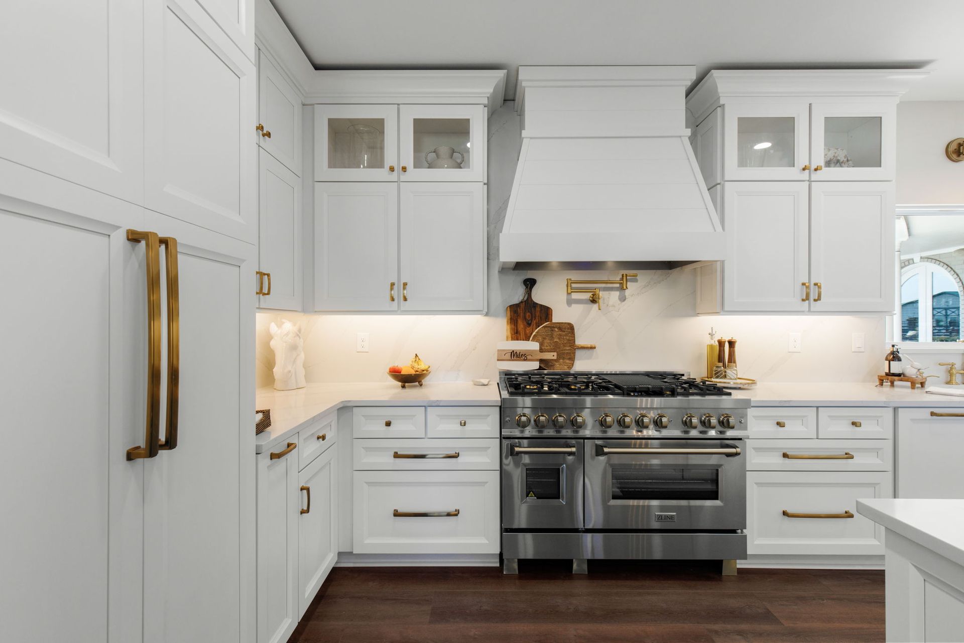 A kitchen with white cabinets and stainless steel appliances.