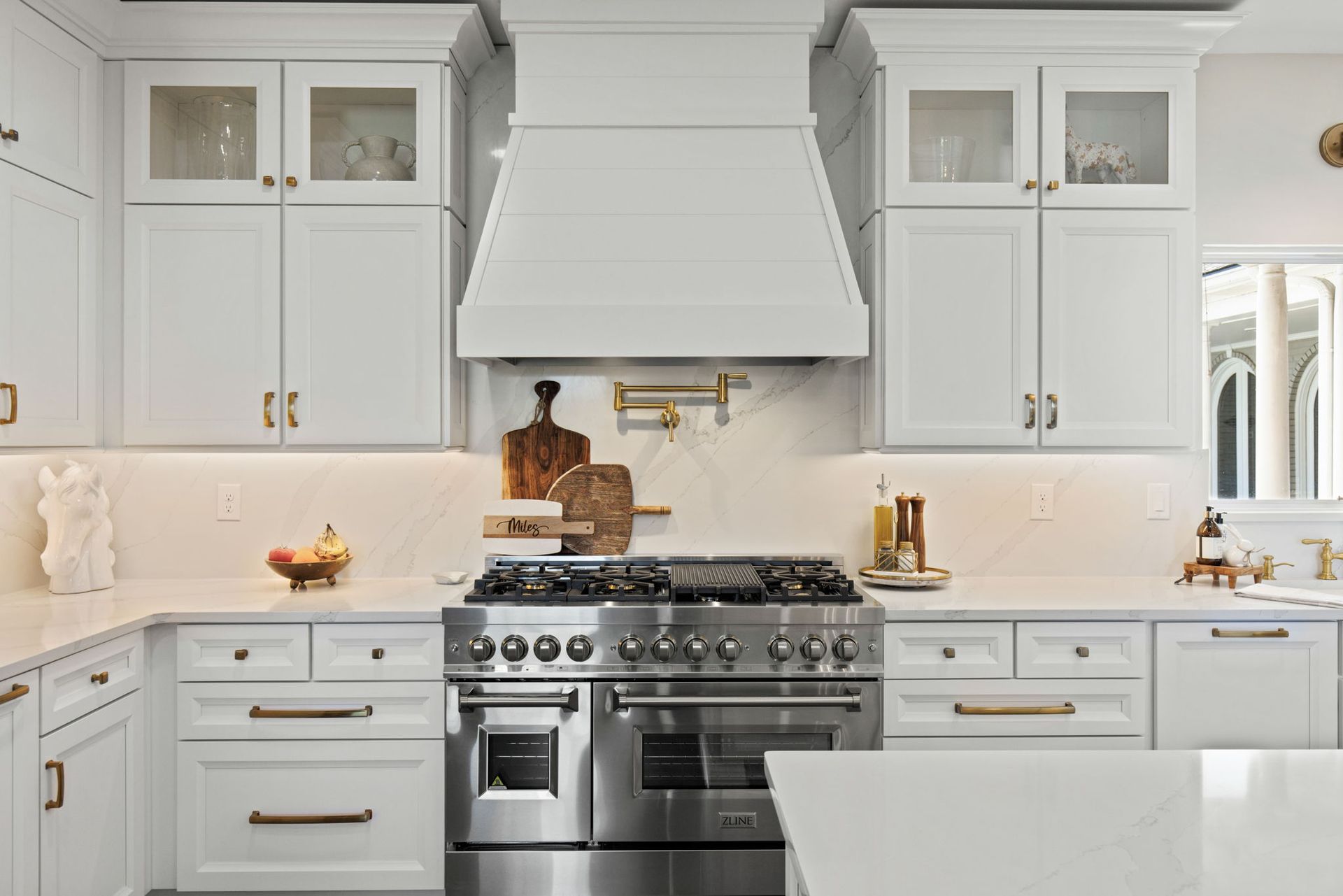 A kitchen with white cabinets and stainless steel appliances.
