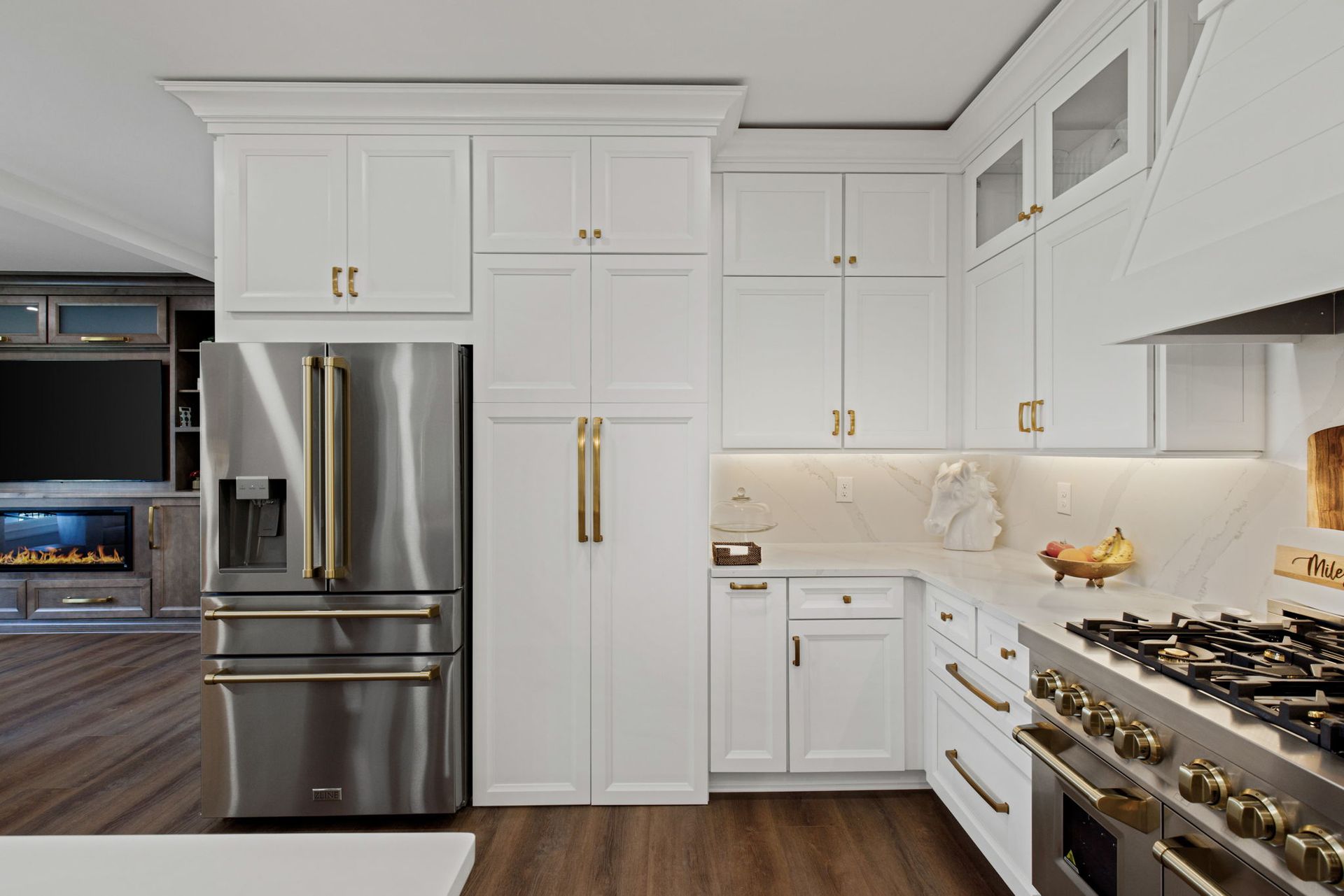 A kitchen with white cabinets and stainless steel appliances