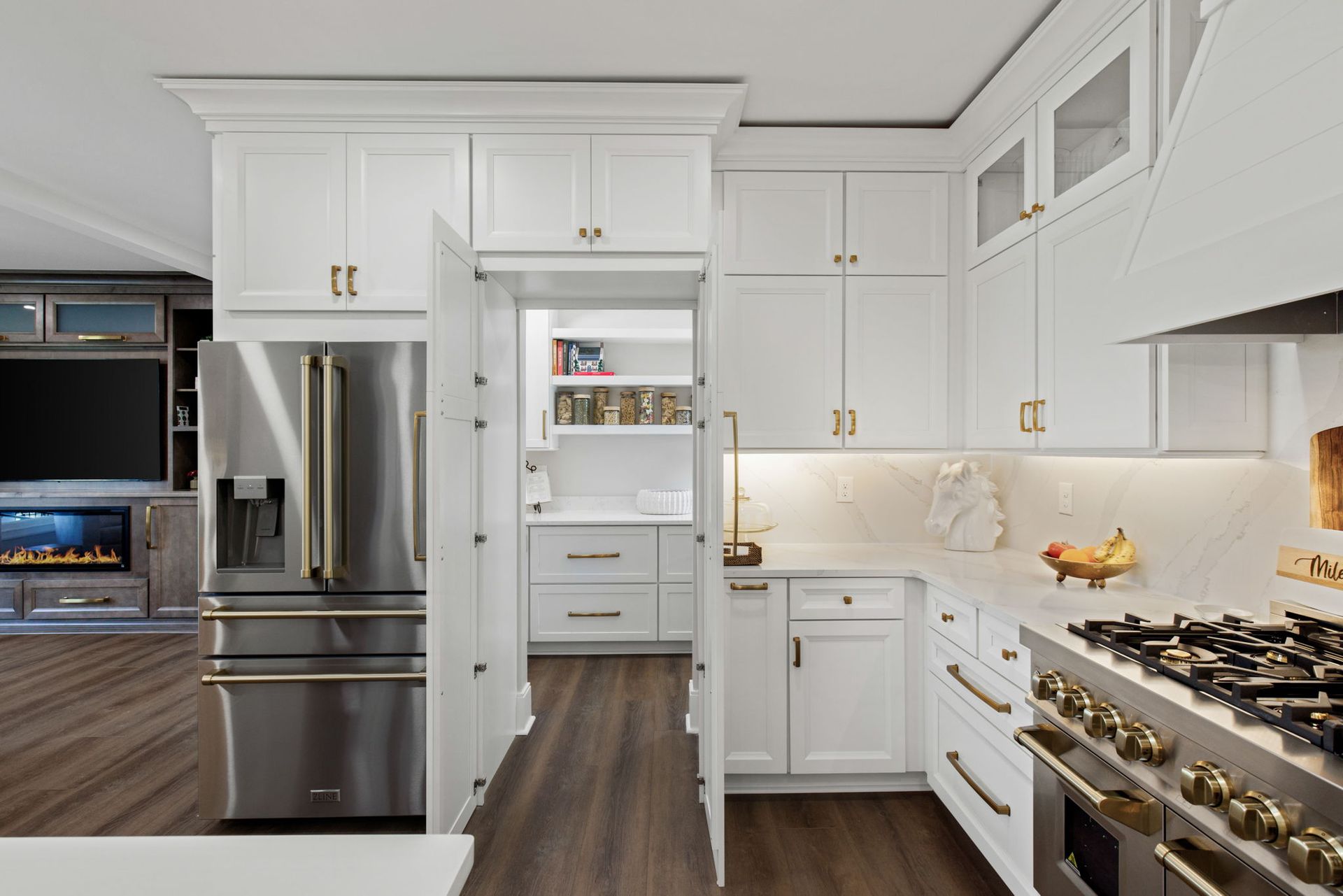 A kitchen with white cabinets and stainless steel appliances.