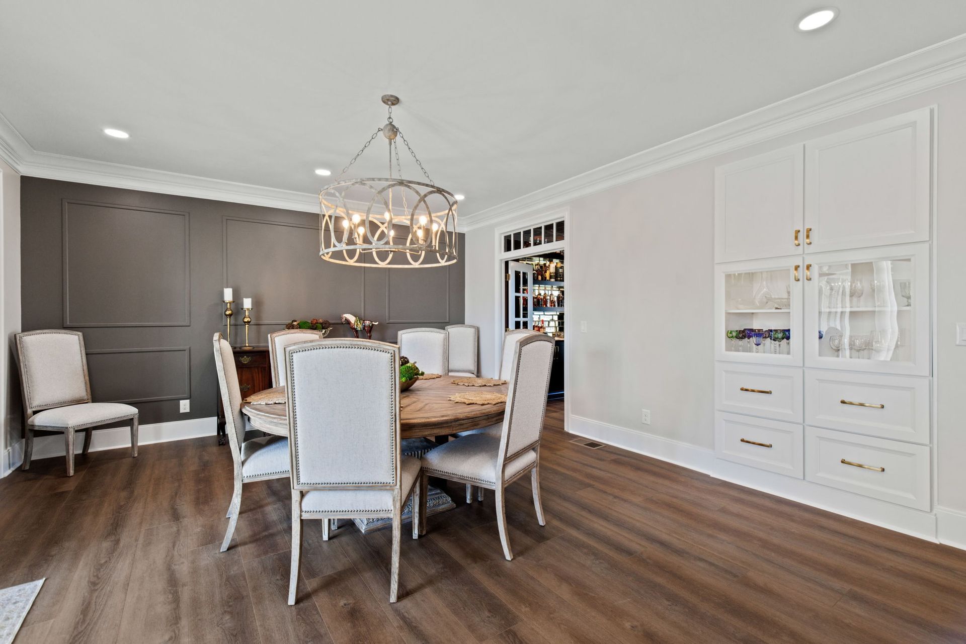 A dining room with a table and chairs and a chandelier.