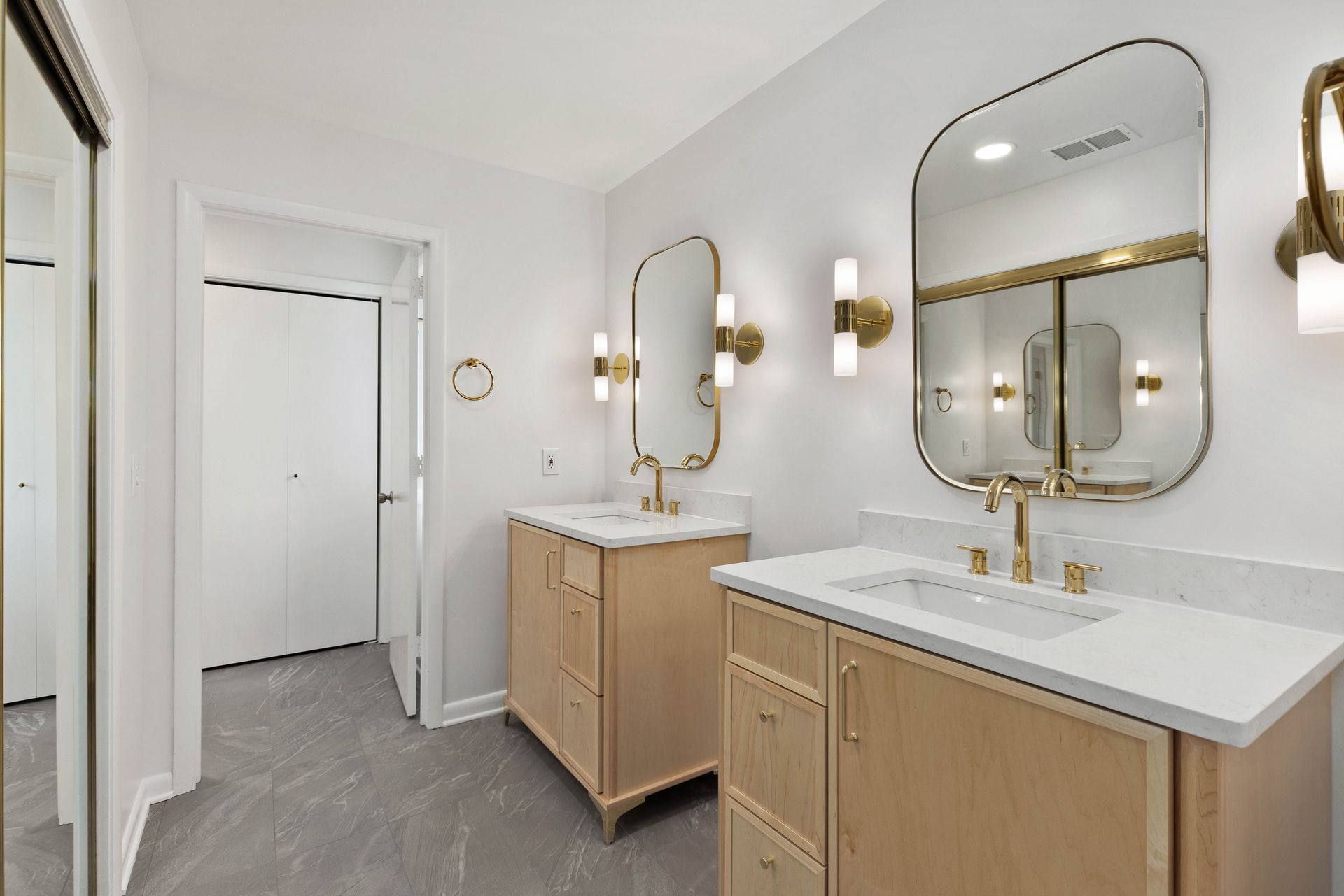 A bathroom with two sinks and two mirrors.