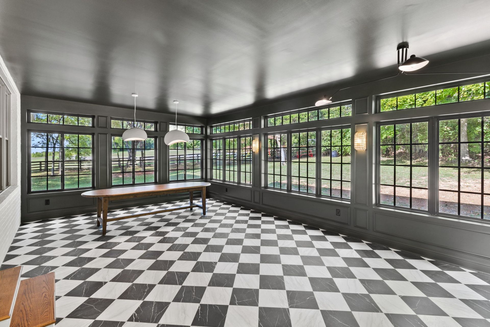 A large room with a checkered floor and a table.