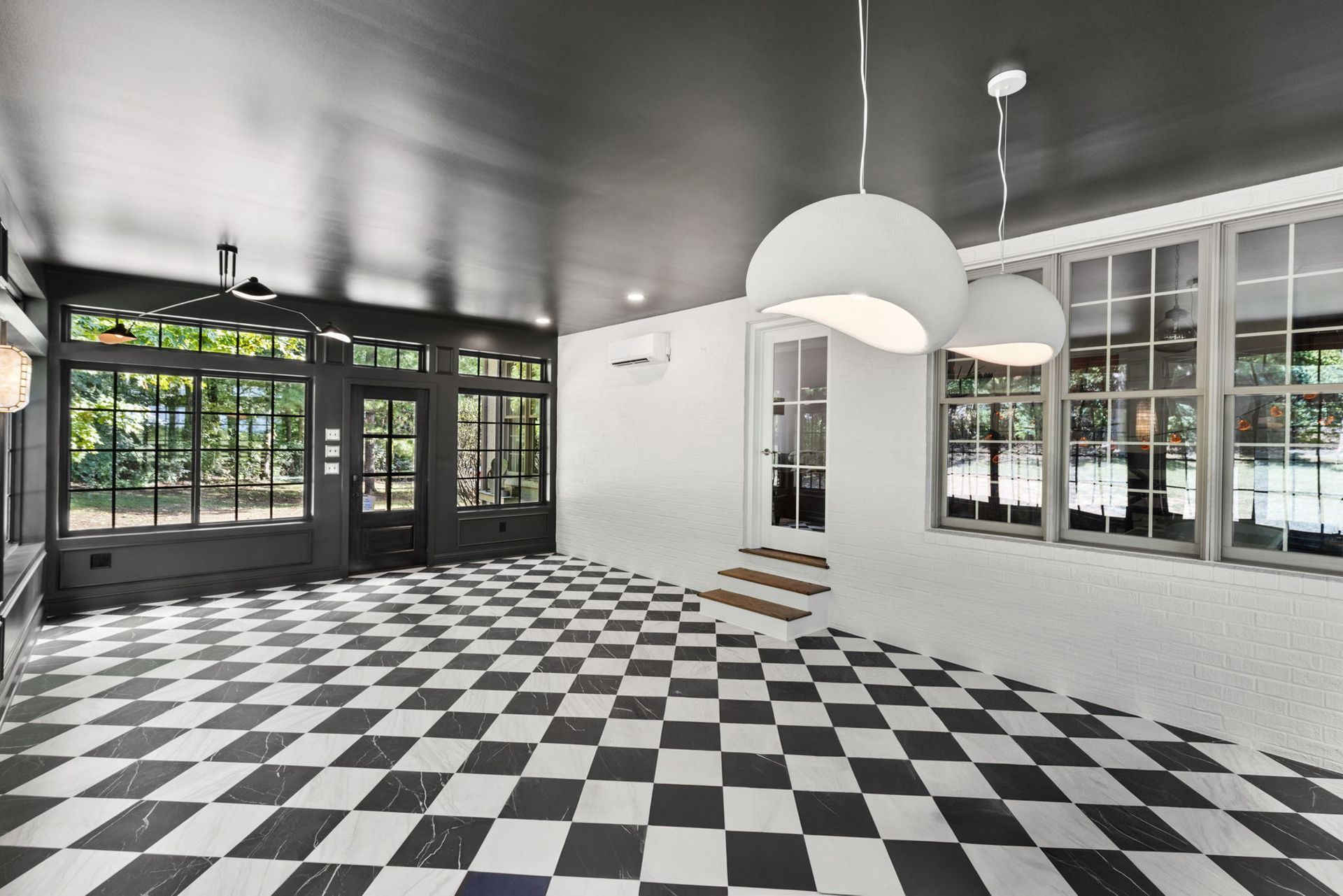 An empty room with a black and white checkered floor