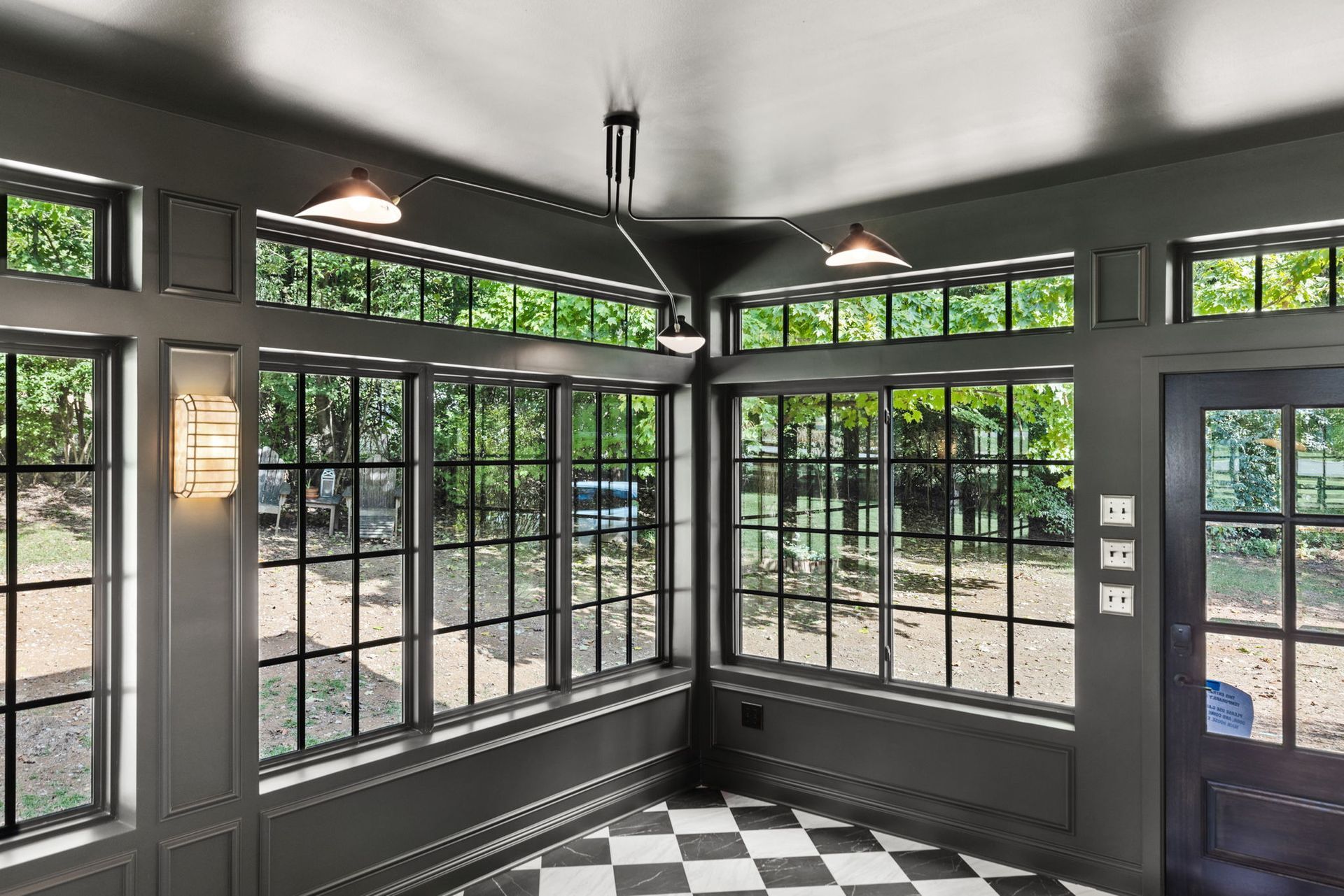 A room with lots of windows and a checkered floor