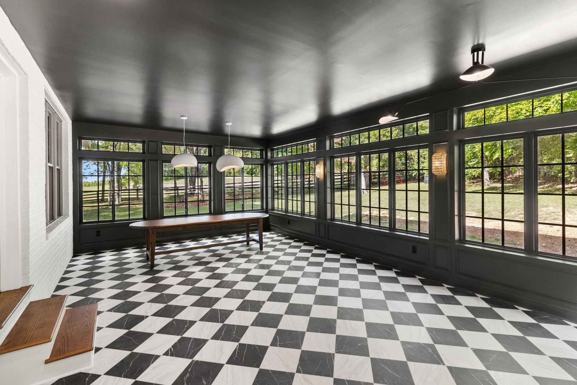 A large room with a checkered floor and a table.