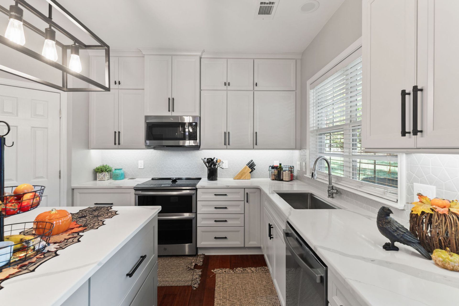 A kitchen with white cabinets and stainless steel appliances