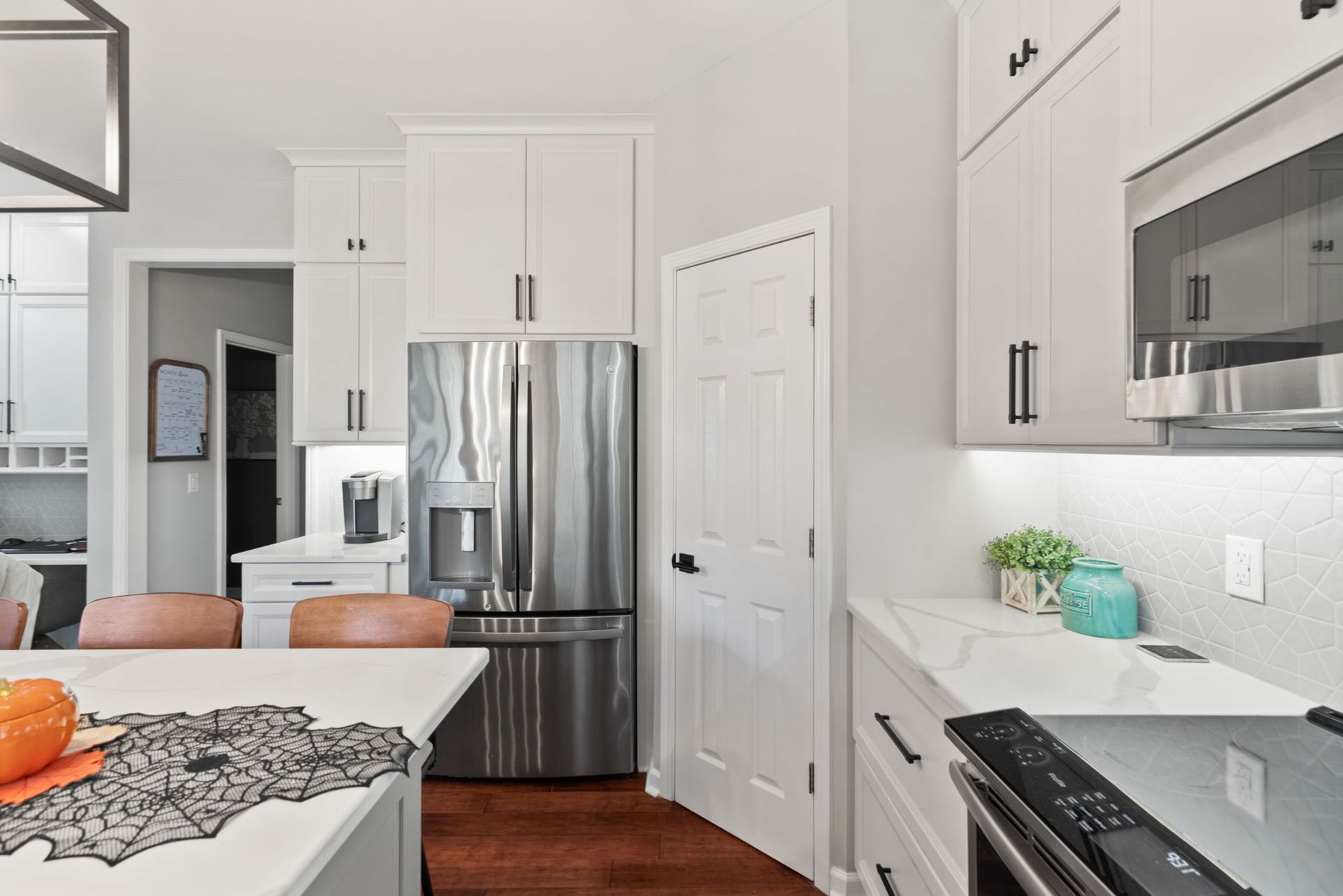 A kitchen with stainless steel appliances and white cabinets