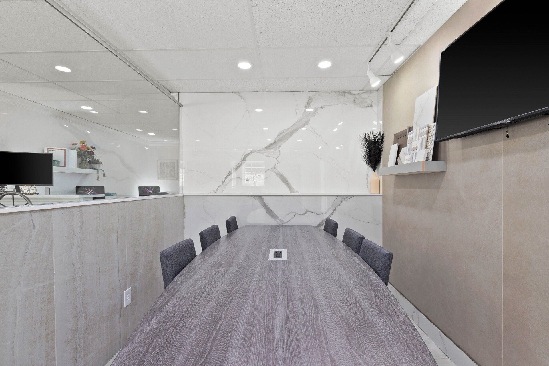 A conference room with a long wooden table and chairs.