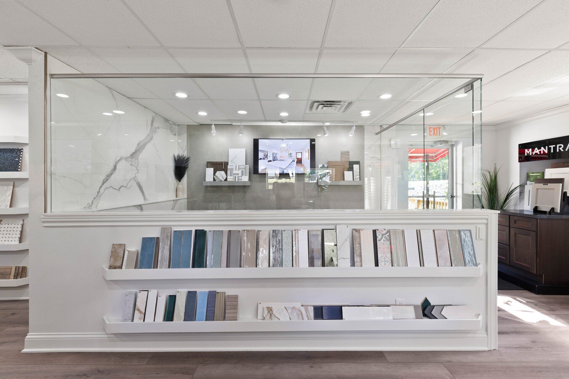 A room with a lot of shelves and a tv on the wall.