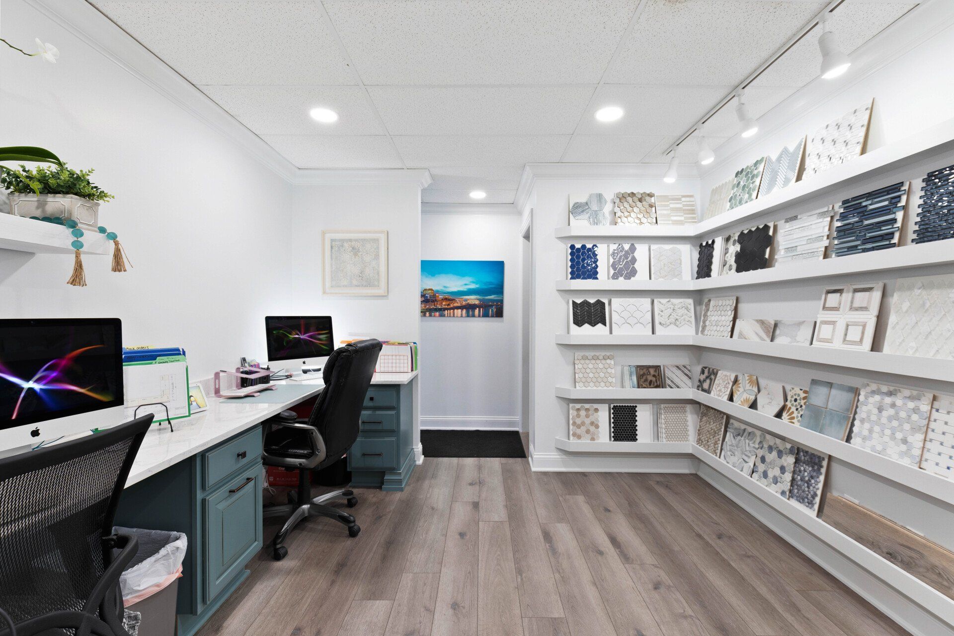 A room with a lot of shelves and a desk with a computer on it.